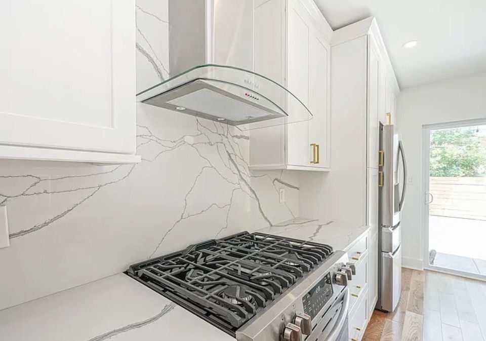 Finished quartz kitchen island with pendant lighting in a Philadelphia rowhome